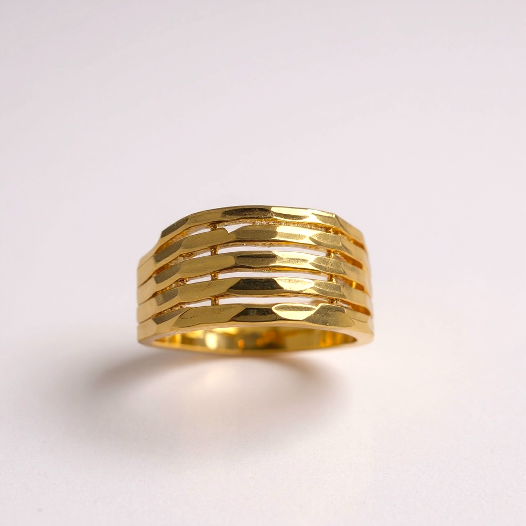 Gold ring with a textured design on a light gray background