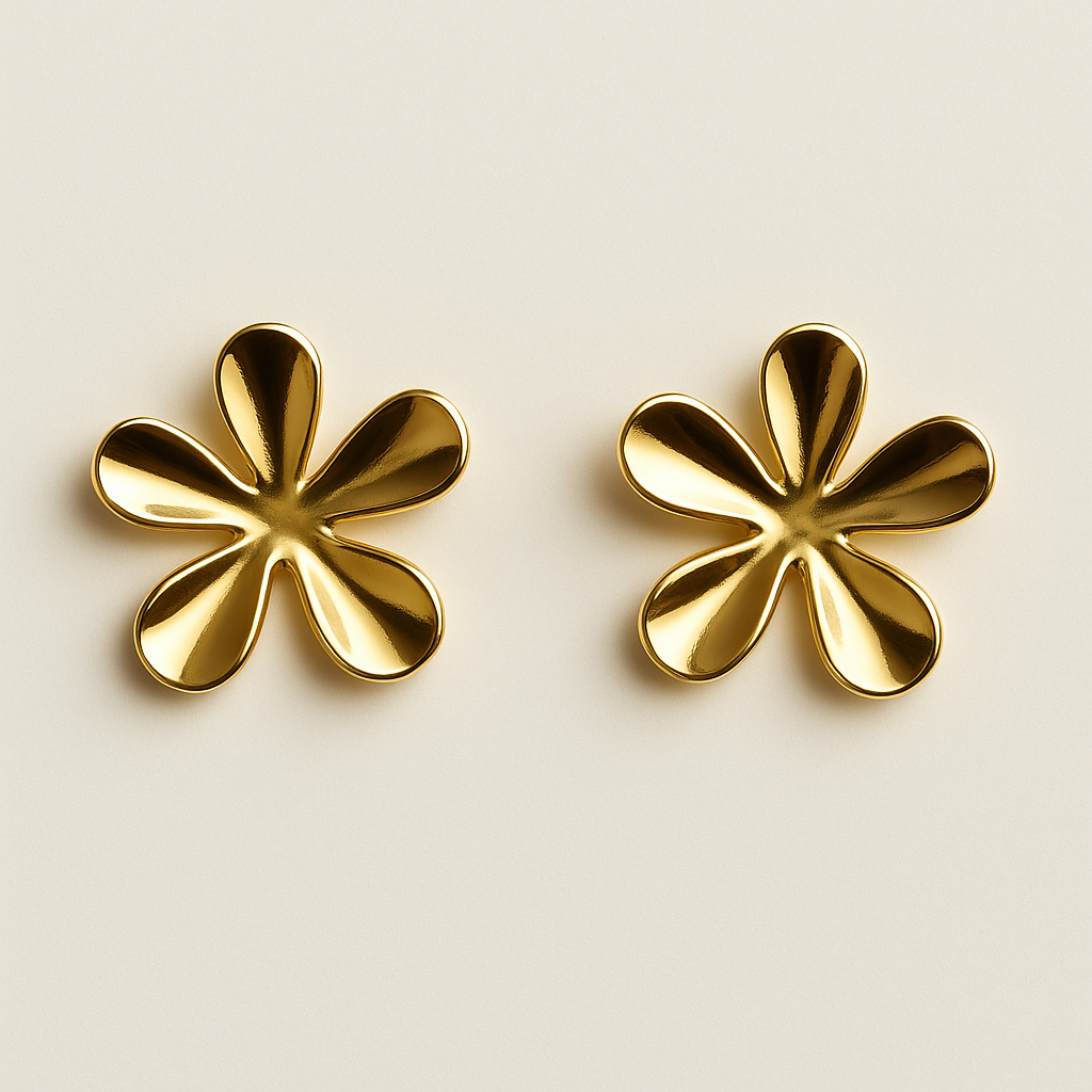 Pair of gold flower-shaped earrings on a beige background