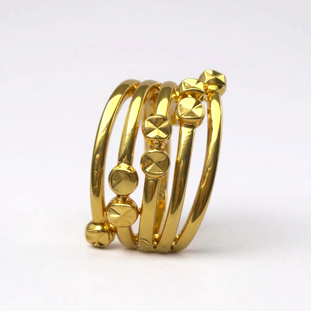 Set of gold bangles on a white background