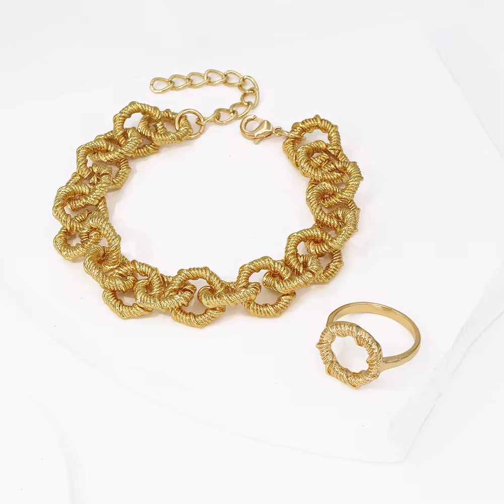18k gold-plated chain bracelet and ring on a white background