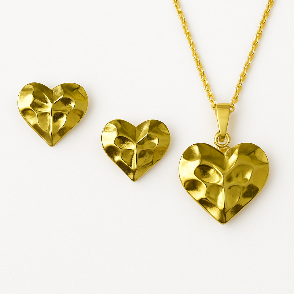 Gold heart-shaped jewelry set on a white background