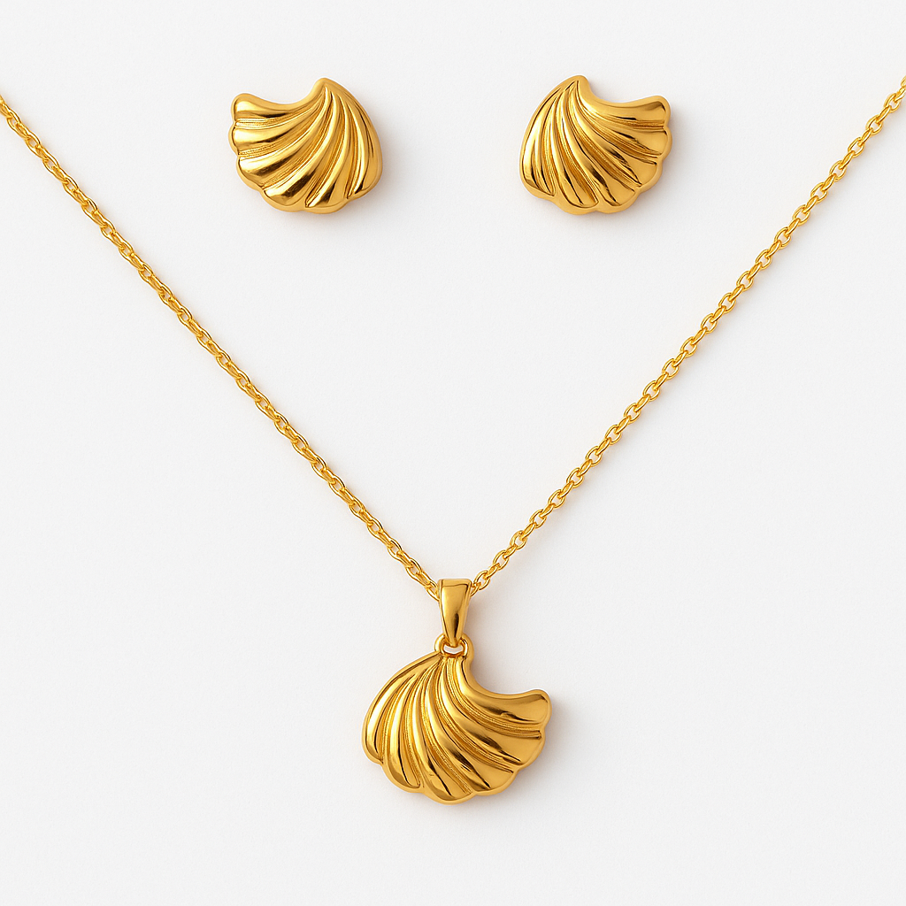 Gold necklace and earrings set on a white background