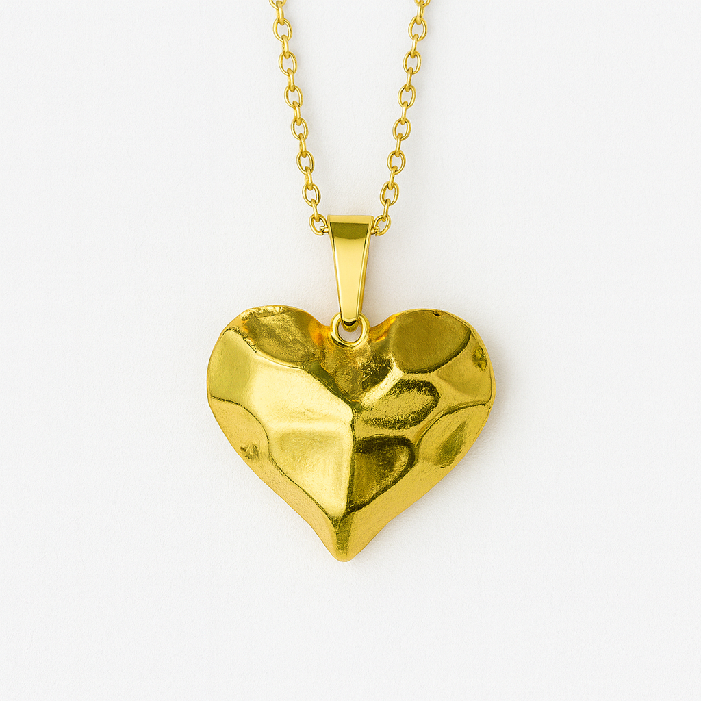Gold heart-shaped pendant on a chain against a white background