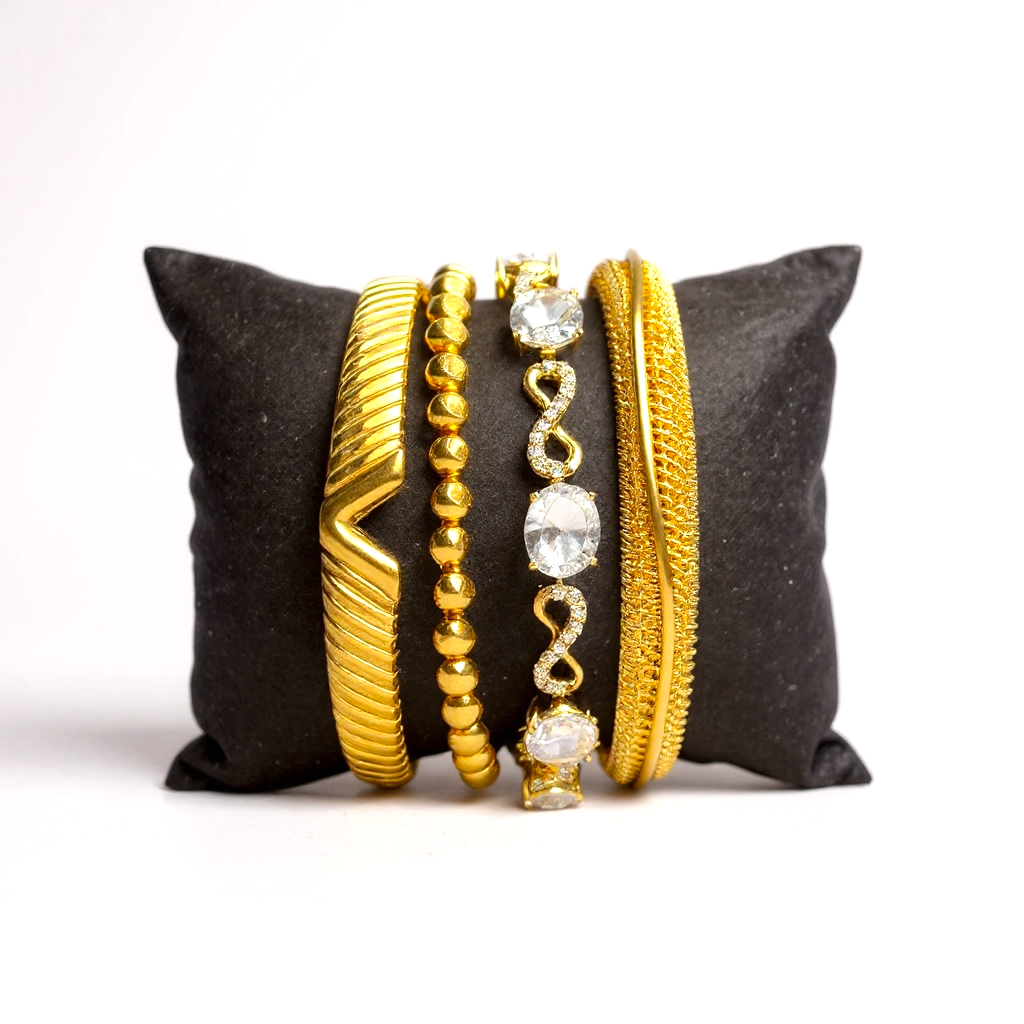 18k Gold-plated 2 bracelets and 2 bangles with crystals on a black pillow