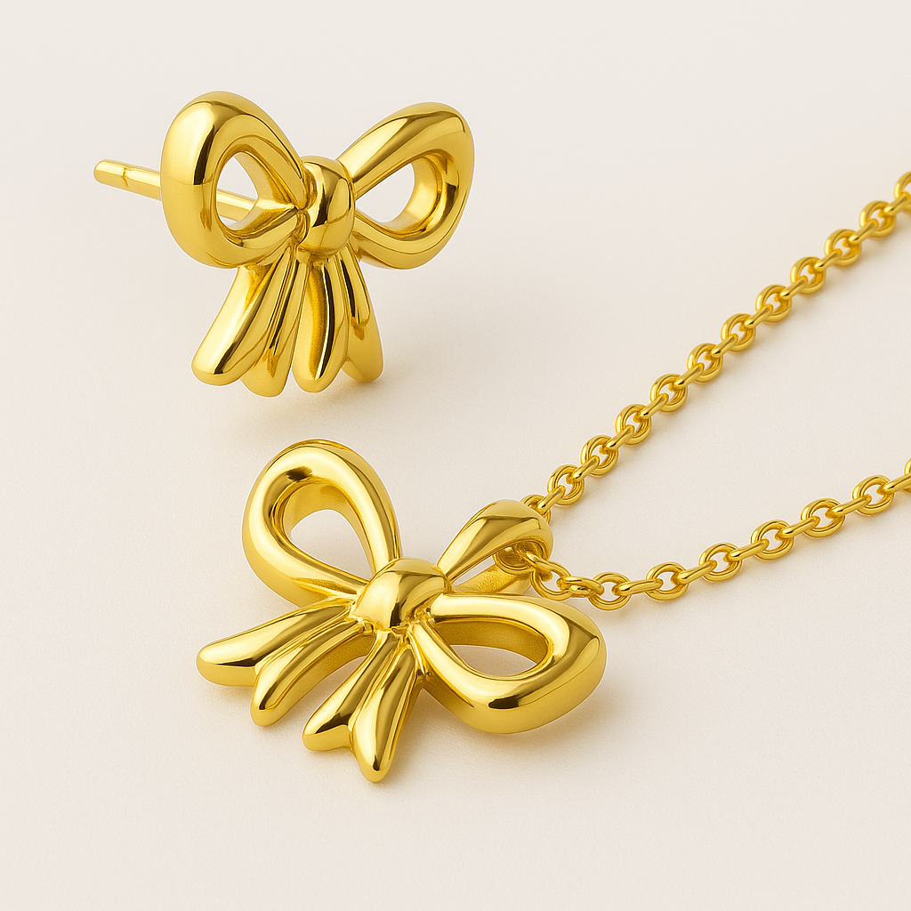 Gold bow-shaped necklace on a light beige background