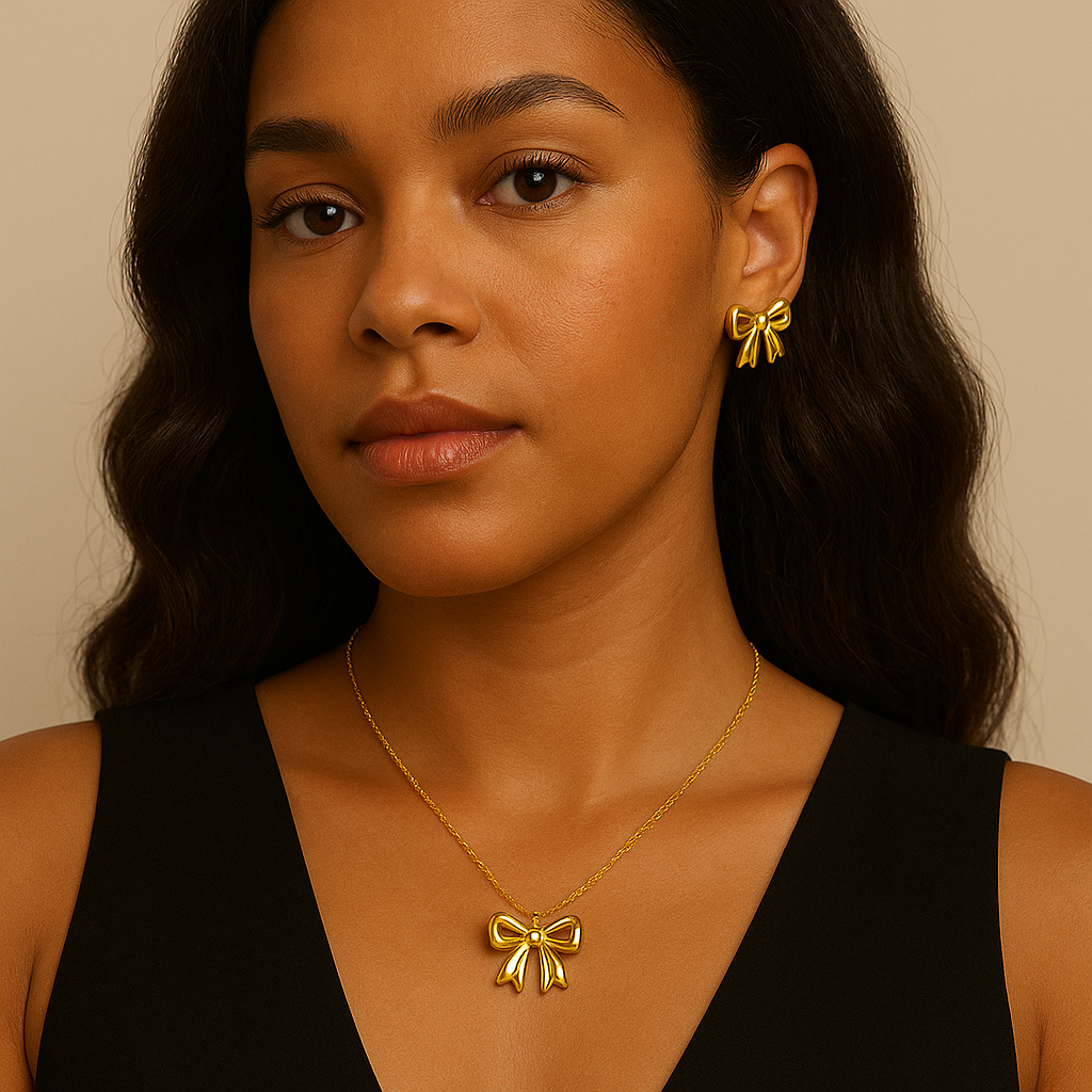 Woman wearing a gold bow necklace and earrings against a beige background