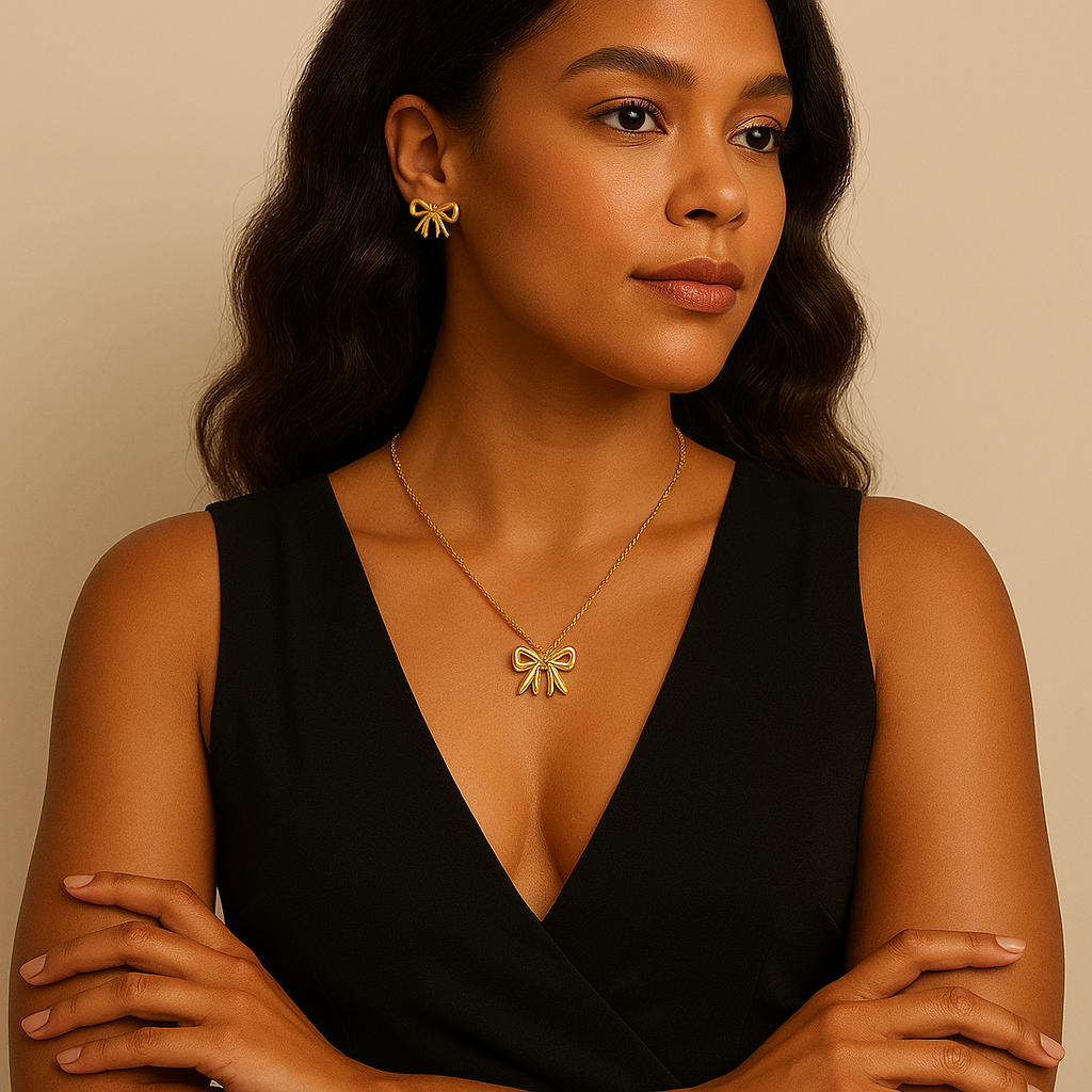 Woman wearing a black dress with gold jewelry against a beige background