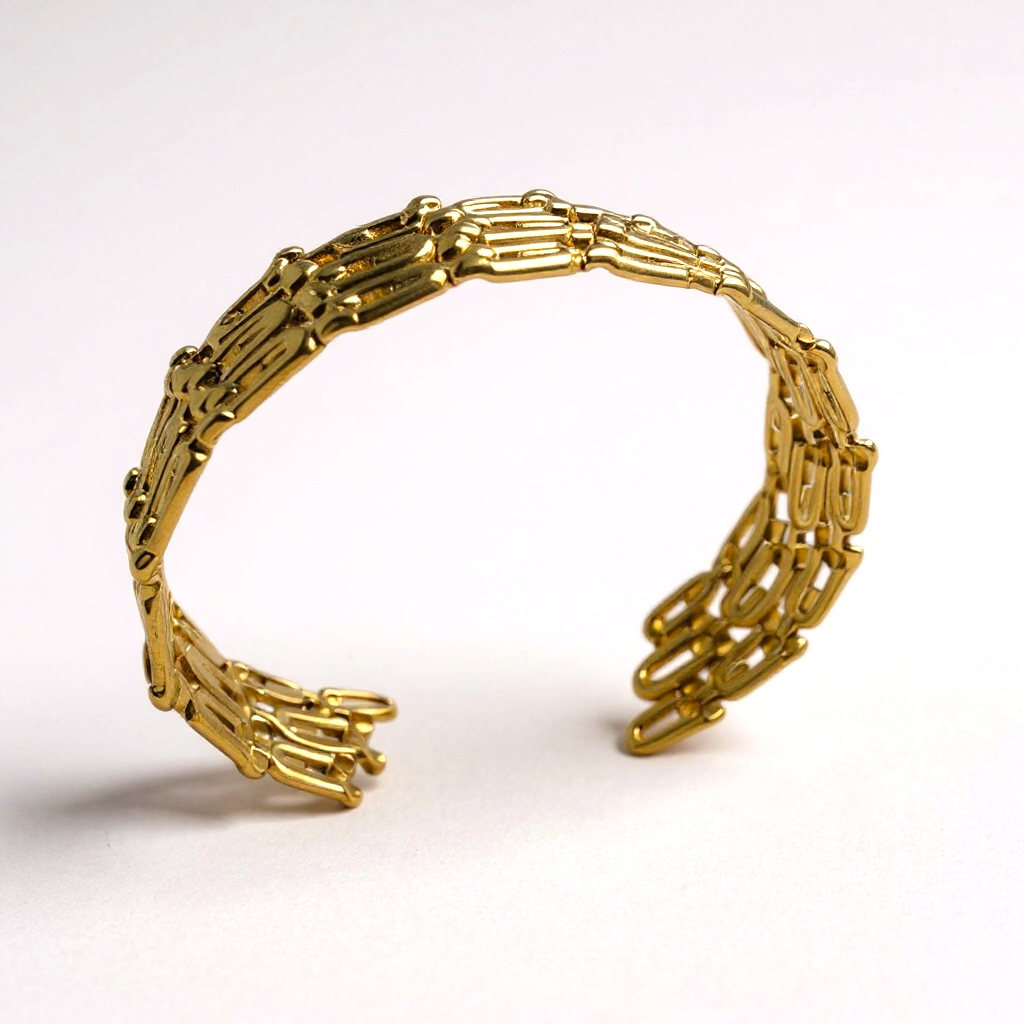 Gold bracelet with a unique design on a white background