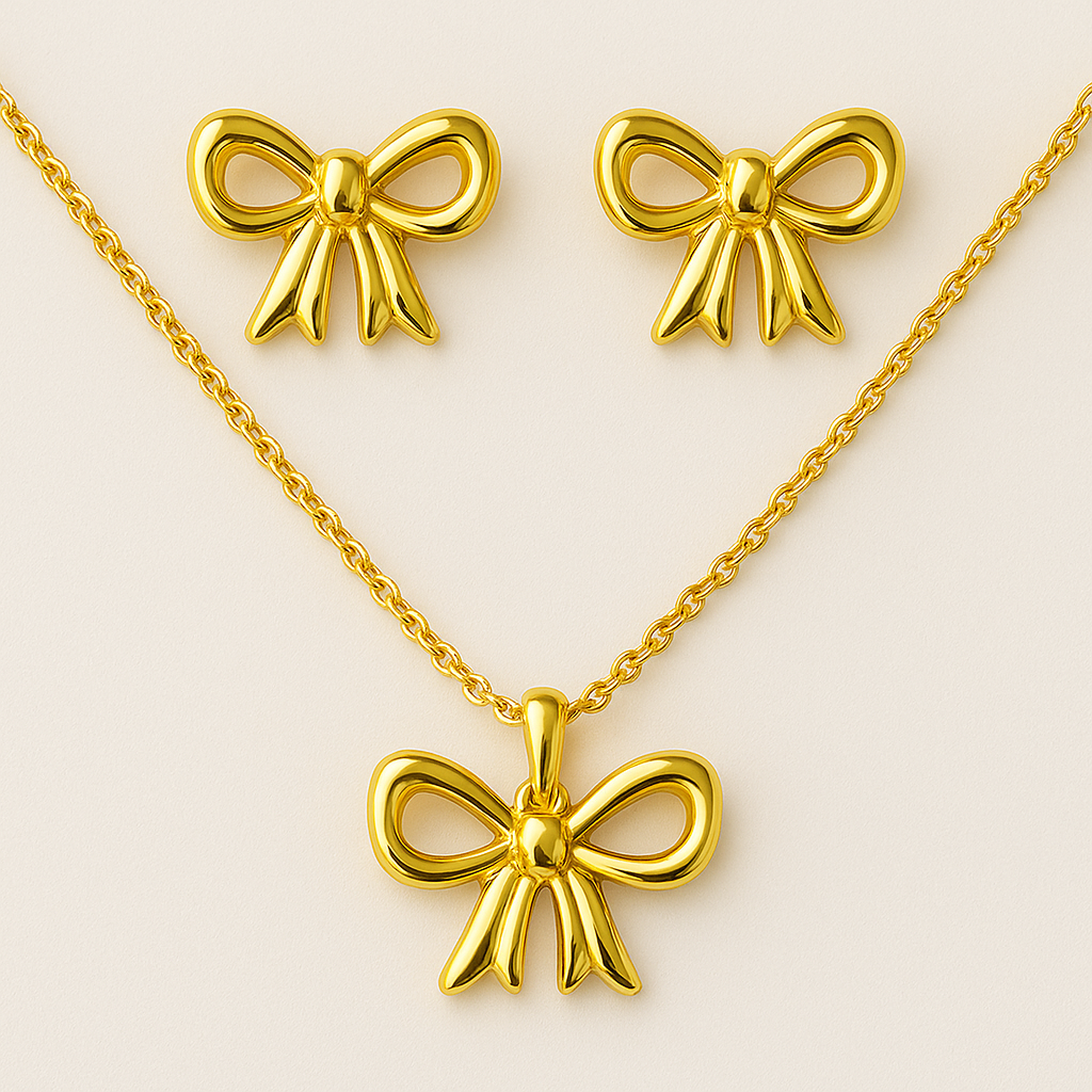 Gold bow-shaped necklace, earrings, and pendant on a beige background