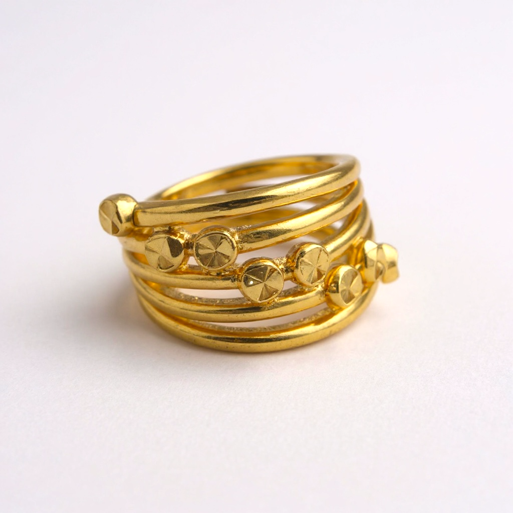 Stack of gold rings on a light background